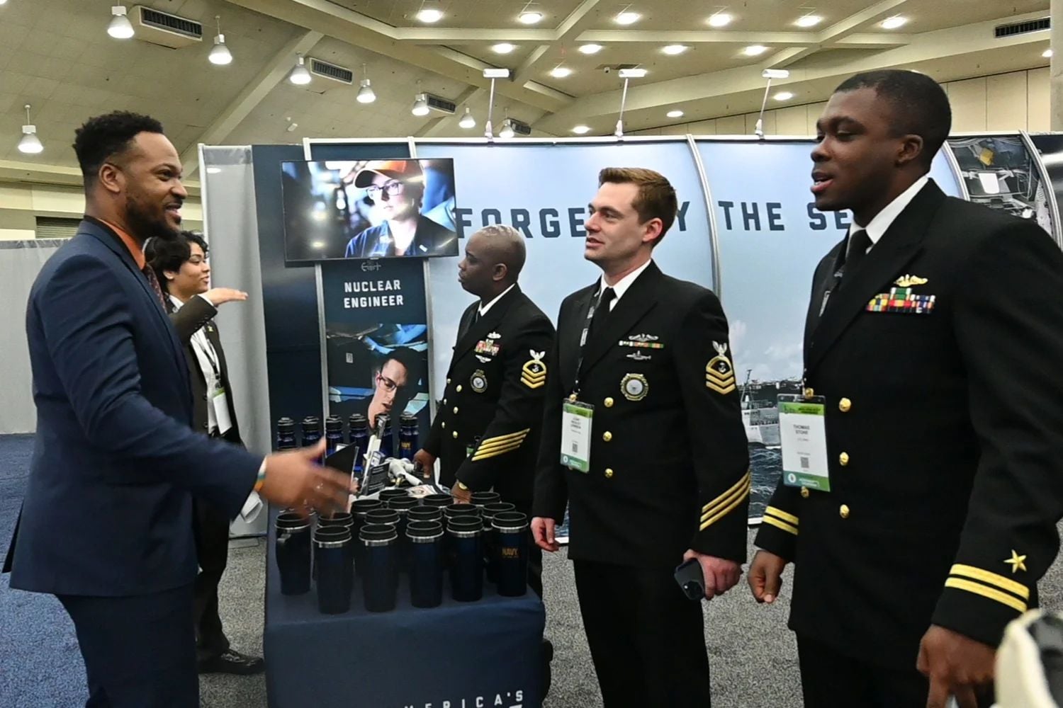 Chief Navy Counselor Horace Henry, Chief Navy Counselor Wesley Lewison IX, and Lt. Thomas Stone speak to recruiting prospects during the Black Engineer of the Year Awards (BEYA) Science, Technology, Engineering, and Mathematics (STEM) Conference held in Baltimore.