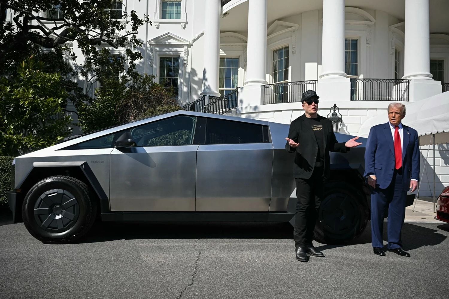 US President Donald Trump and Tesla CEO Elon Musk speak to the press as they stand next to a Tesla Cybertruck on the South Portico of the White House on March 11, 2025 in Washington, DC
